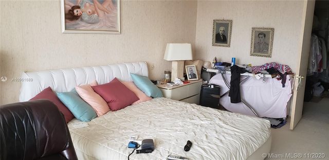 a view of a hallway with chandelier