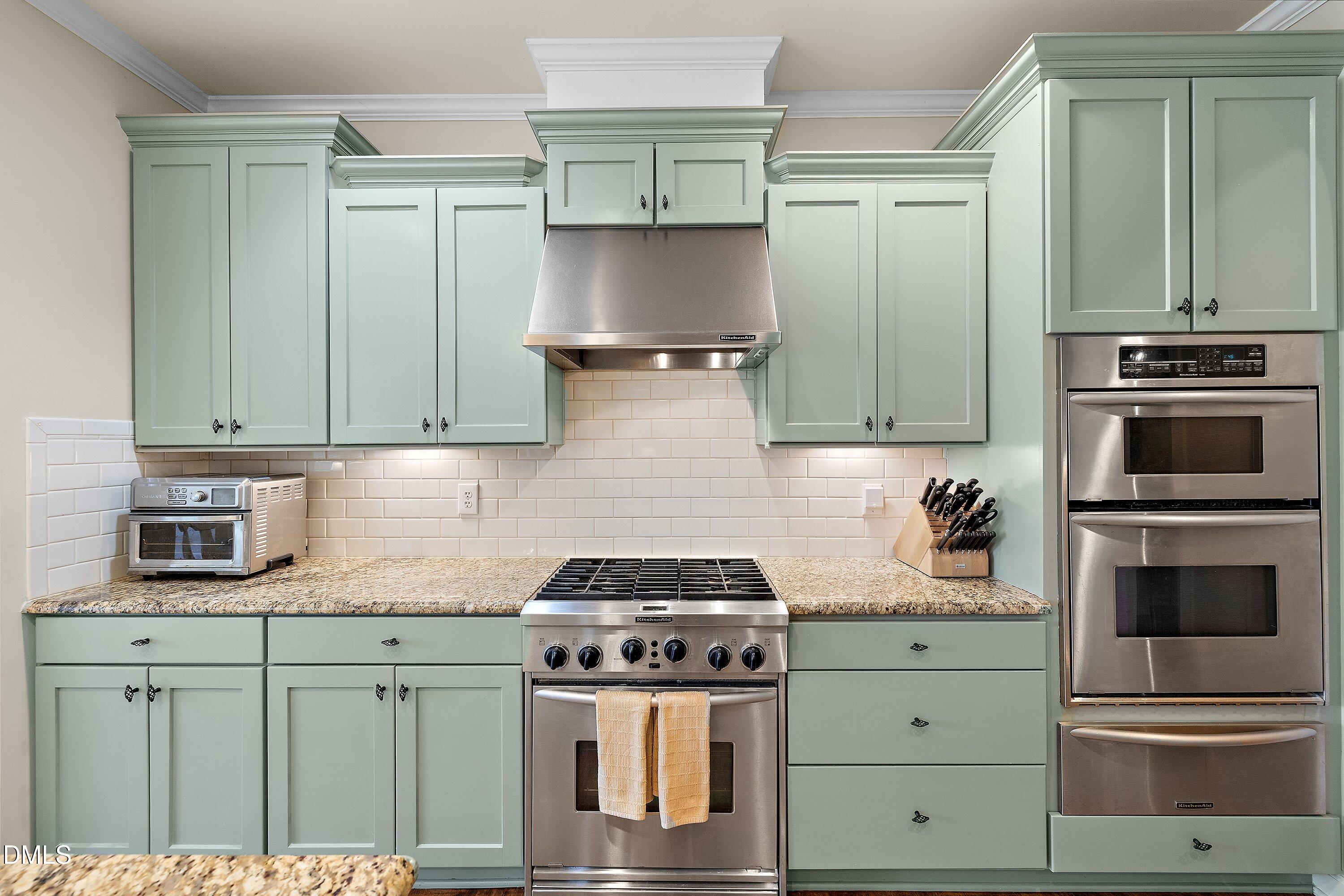 701 Royal Tower Way Cary, NC 27513 - Photo 18 of 82 a kitchen with granite countertop a stove and a microwave