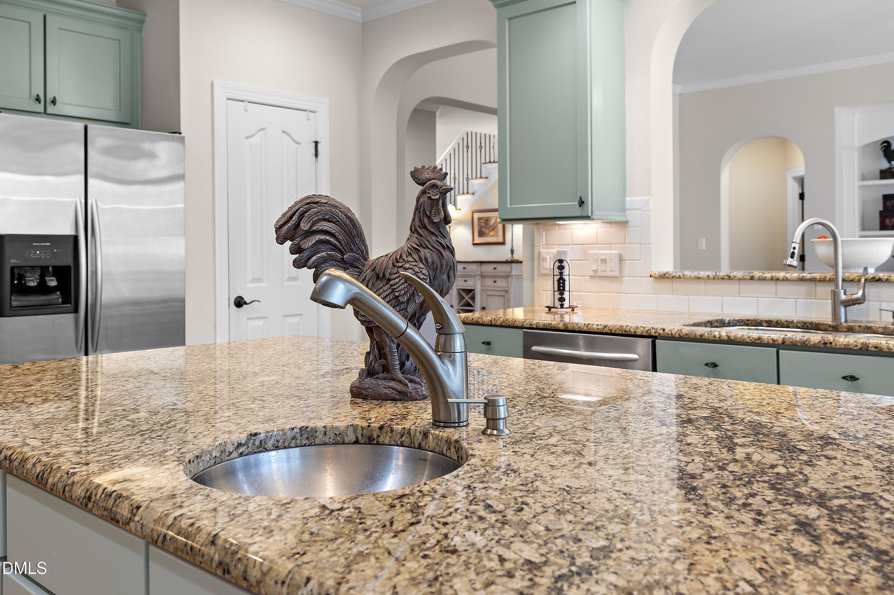 701 Royal Tower Way Cary, NC 27513 - Photo 19 of 82 a kitchen with kitchen island granite countertop a sink and a refrigerator