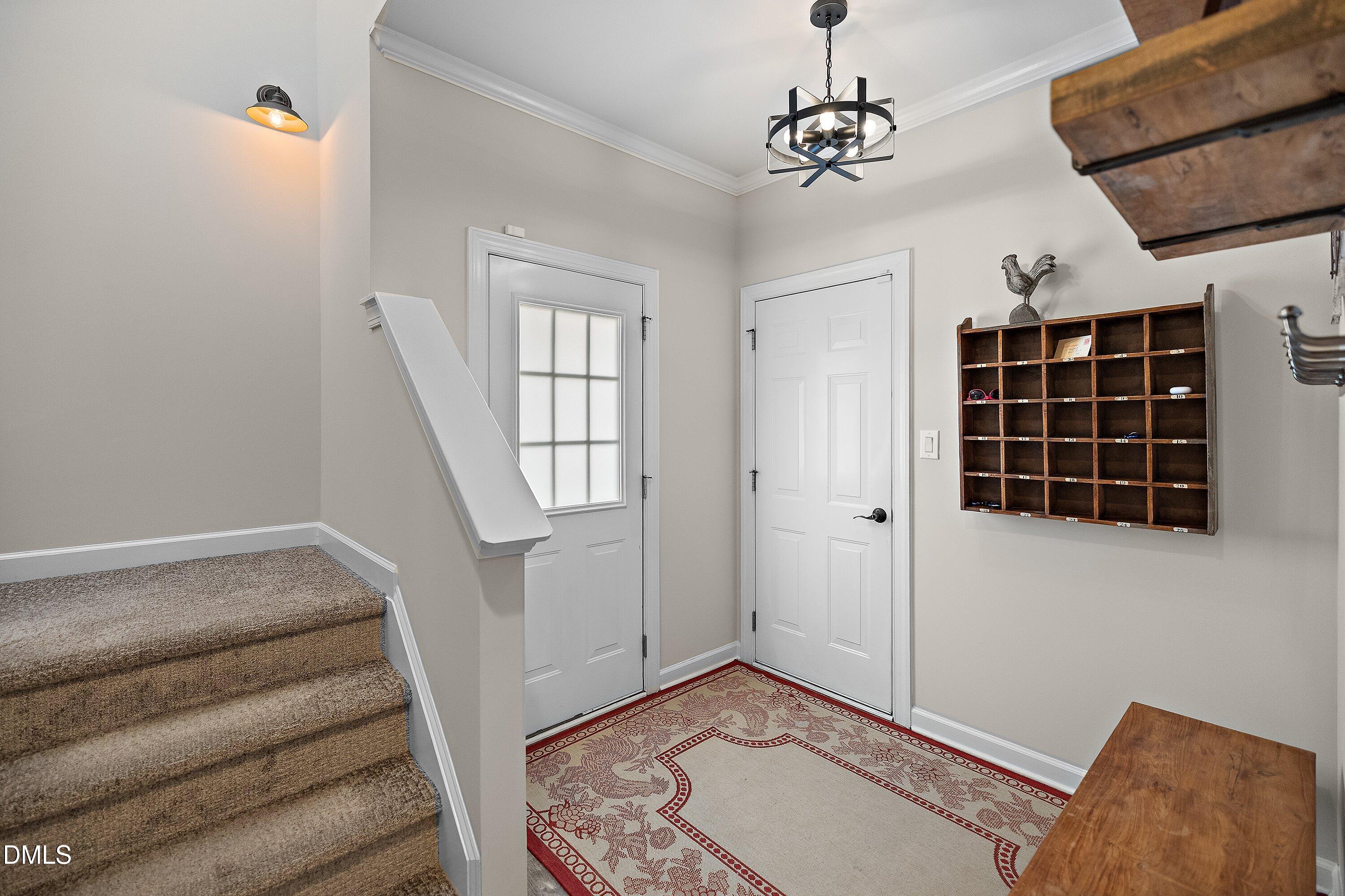 701 Royal Tower Way Cary, NC 27513 - Photo 25 of 82 a view of entryway with stairs and wooden floor