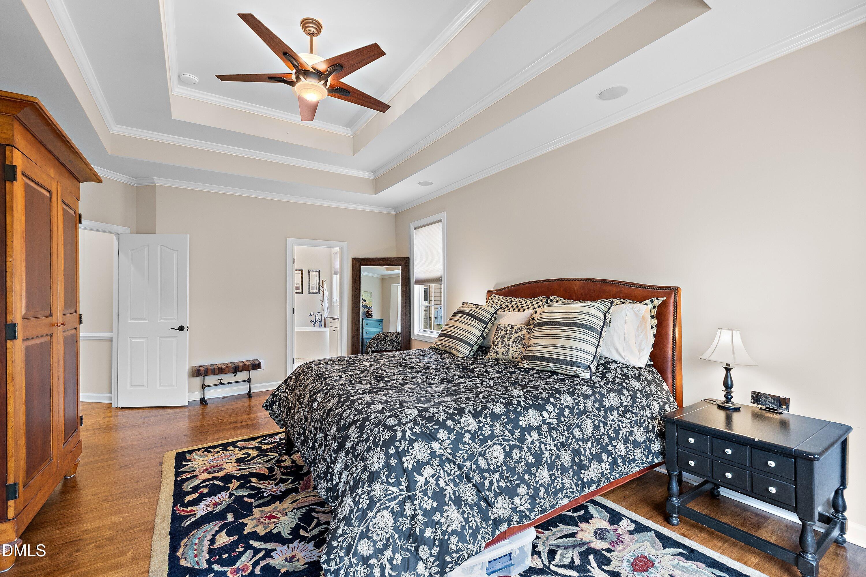 701 Royal Tower Way Cary, NC 27513 - Photo 34 of 82 a bedroom with bed and wooden floor