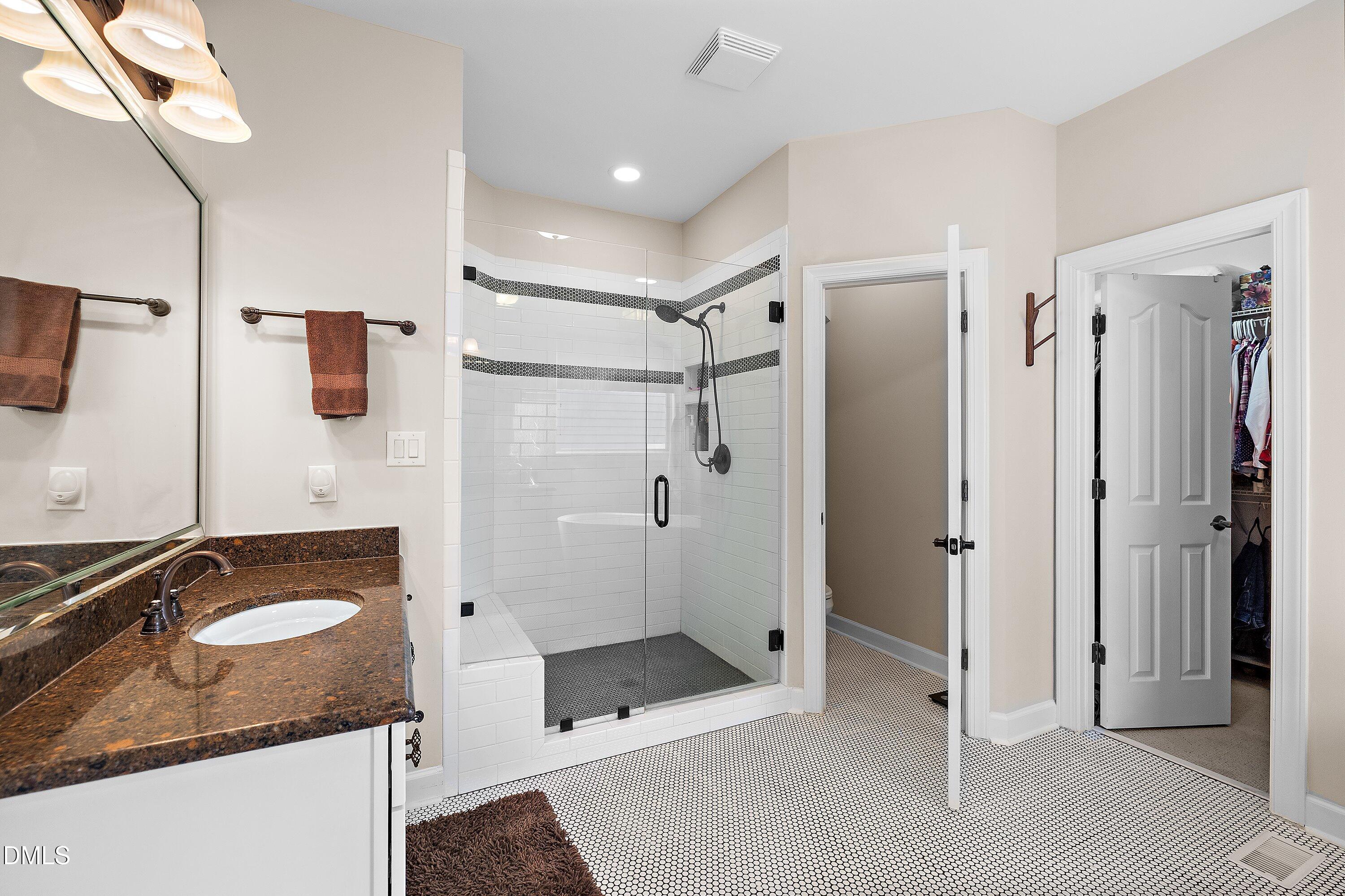 701 Royal Tower Way Cary, NC 27513 - Photo 38 of 82 a bathroom with a sink double vanity granite shower and a mirror