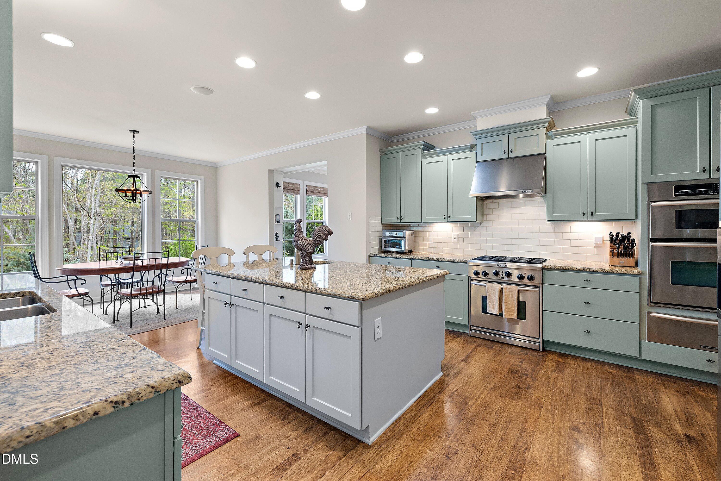 701 Royal Tower Way Cary, NC 27513 - Photo 4 of 82 a kitchen with stainless steel appliances granite countertop a stove oven and a refrigerator