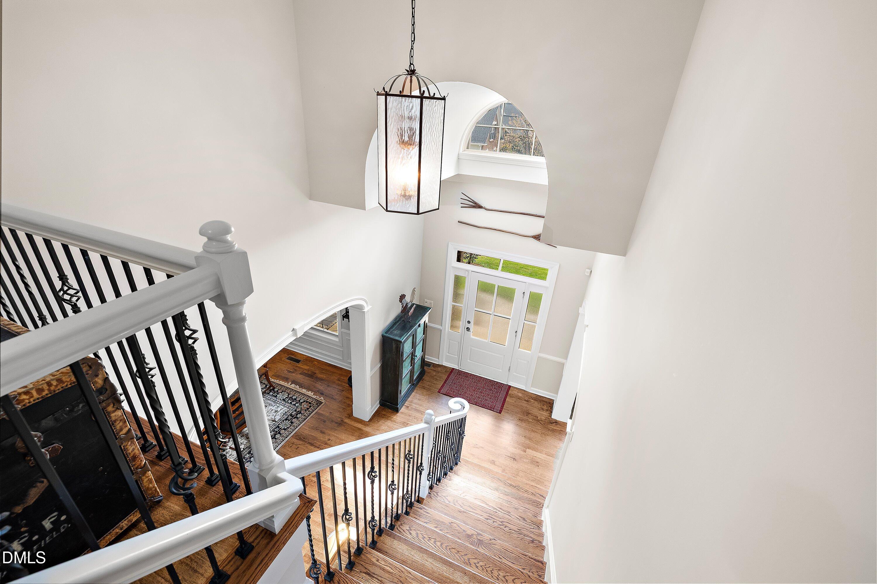 701 Royal Tower Way Cary, NC 27513 - Photo 43 of 82 a view of a hallway to a livingroom with wooden floor and furniture