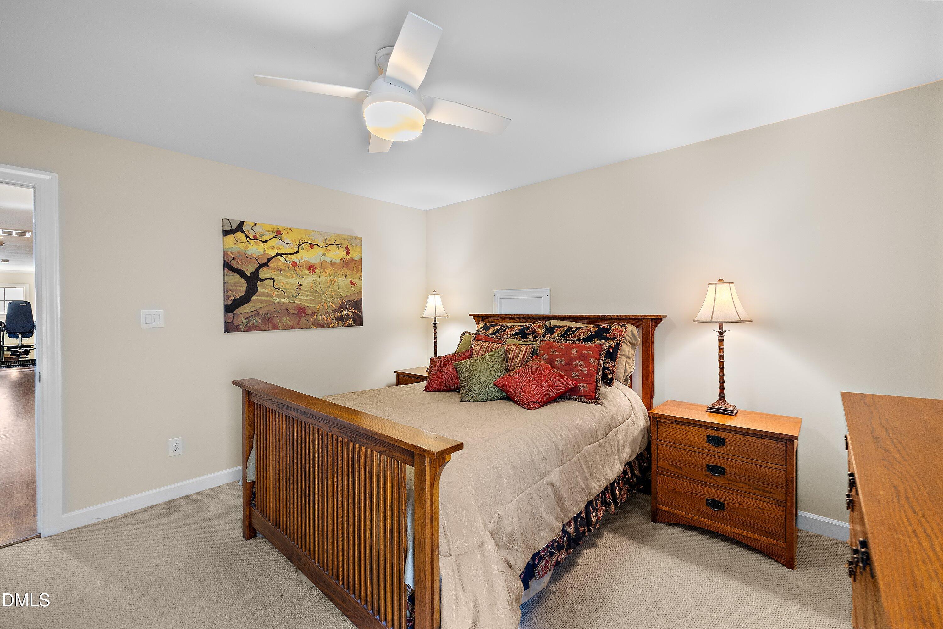 701 Royal Tower Way Cary, NC 27513 - Photo 51 of 82 a bedroom with a bed and a lamp on the dresser