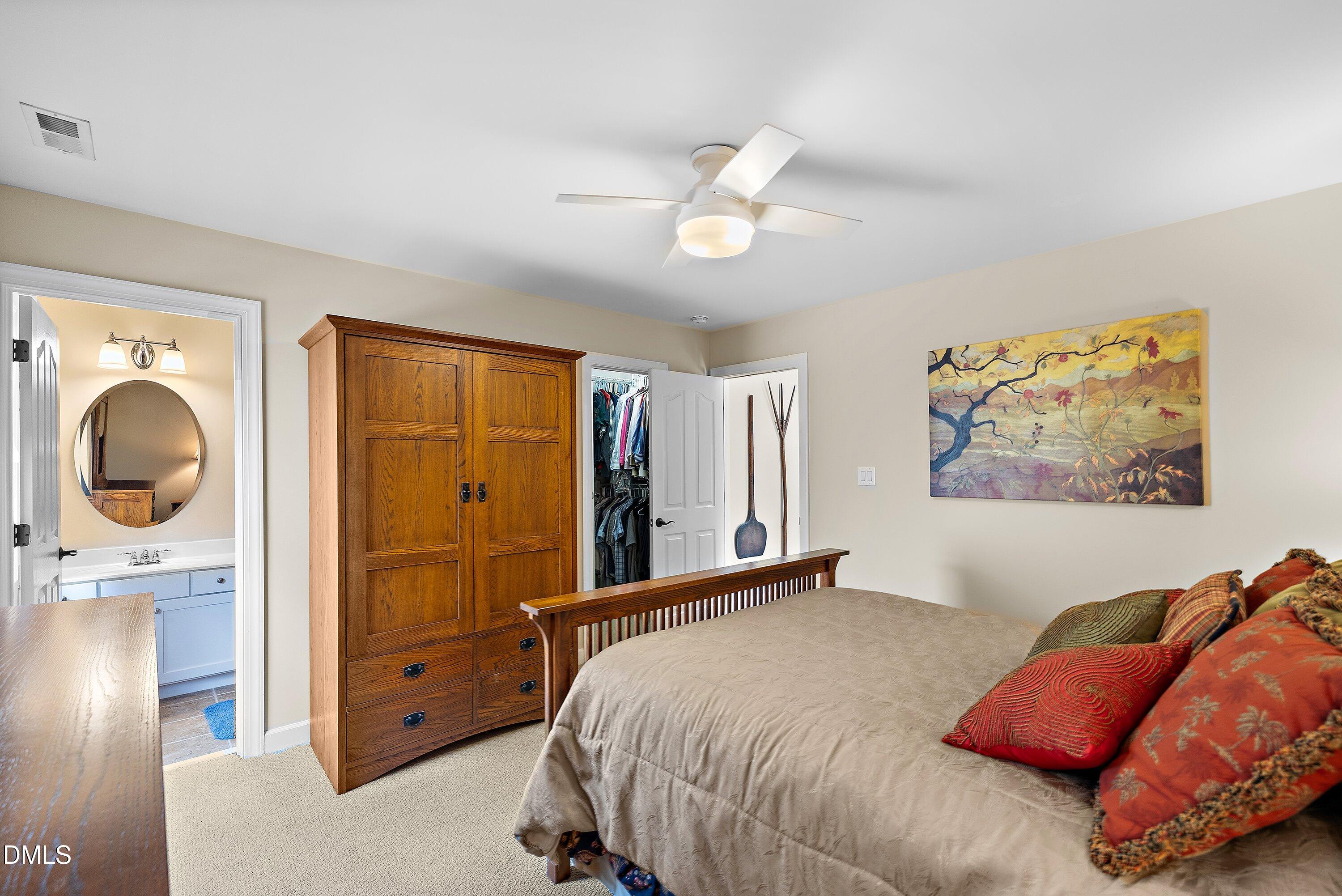701 Royal Tower Way Cary, NC 27513 - Photo 52 of 82 a bedroom with a bed and a painting on the wall