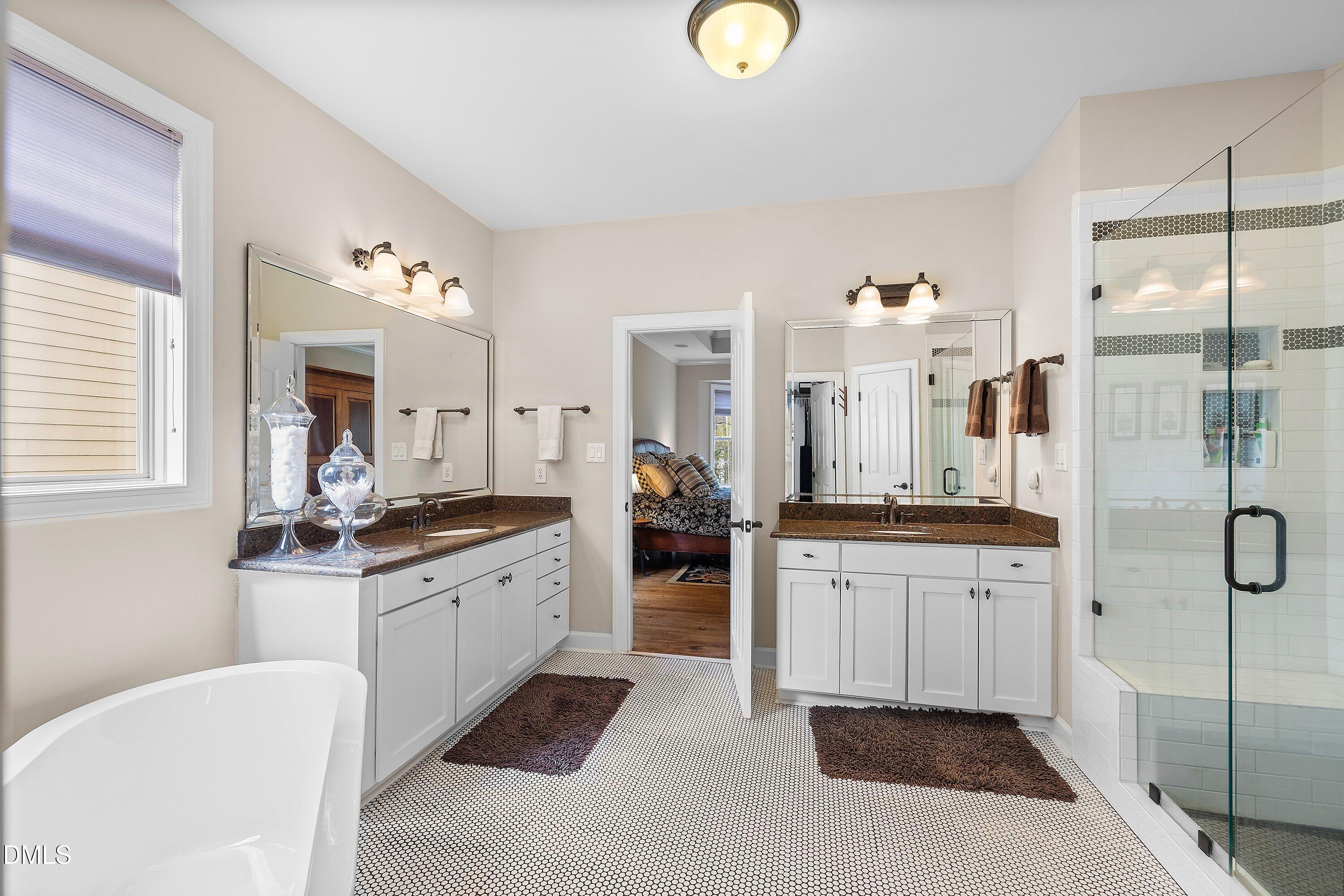 701 Royal Tower Way Cary, NC 27513 - Photo 6 of 82 a large bathroom with a double vanity sink mirror and bathtub