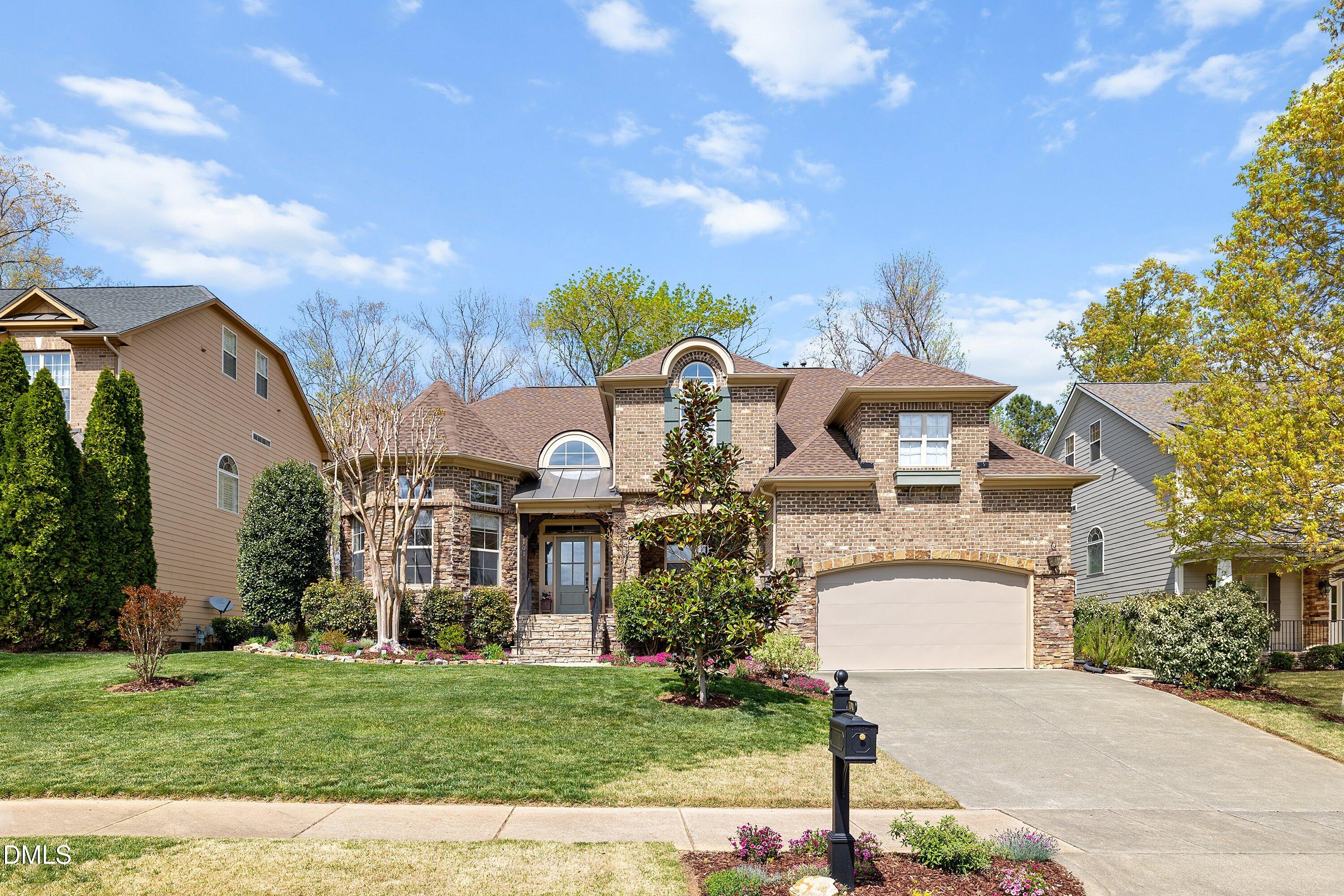 701 Royal Tower Way Cary, NC 27513 - Photo 78 of 82 a front view of a house with a garden and plants