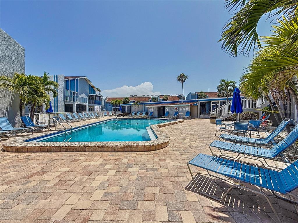 230 Medallion Boulevard, Unit G Madeira Beach, FL 33708 - Photo 33 of 38 a view of house with outdoor space and swimming pool