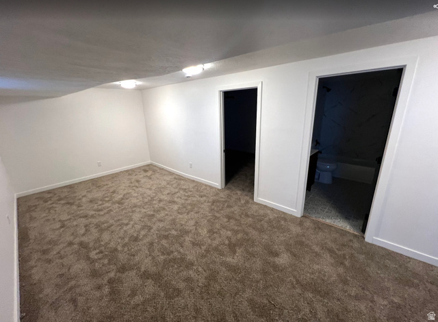 545 23rd Street Ogden, UT 84401 - Photo 17 of 28 Carpeted room featuring white walls, white trim, and two surface-mounted ceiling lights