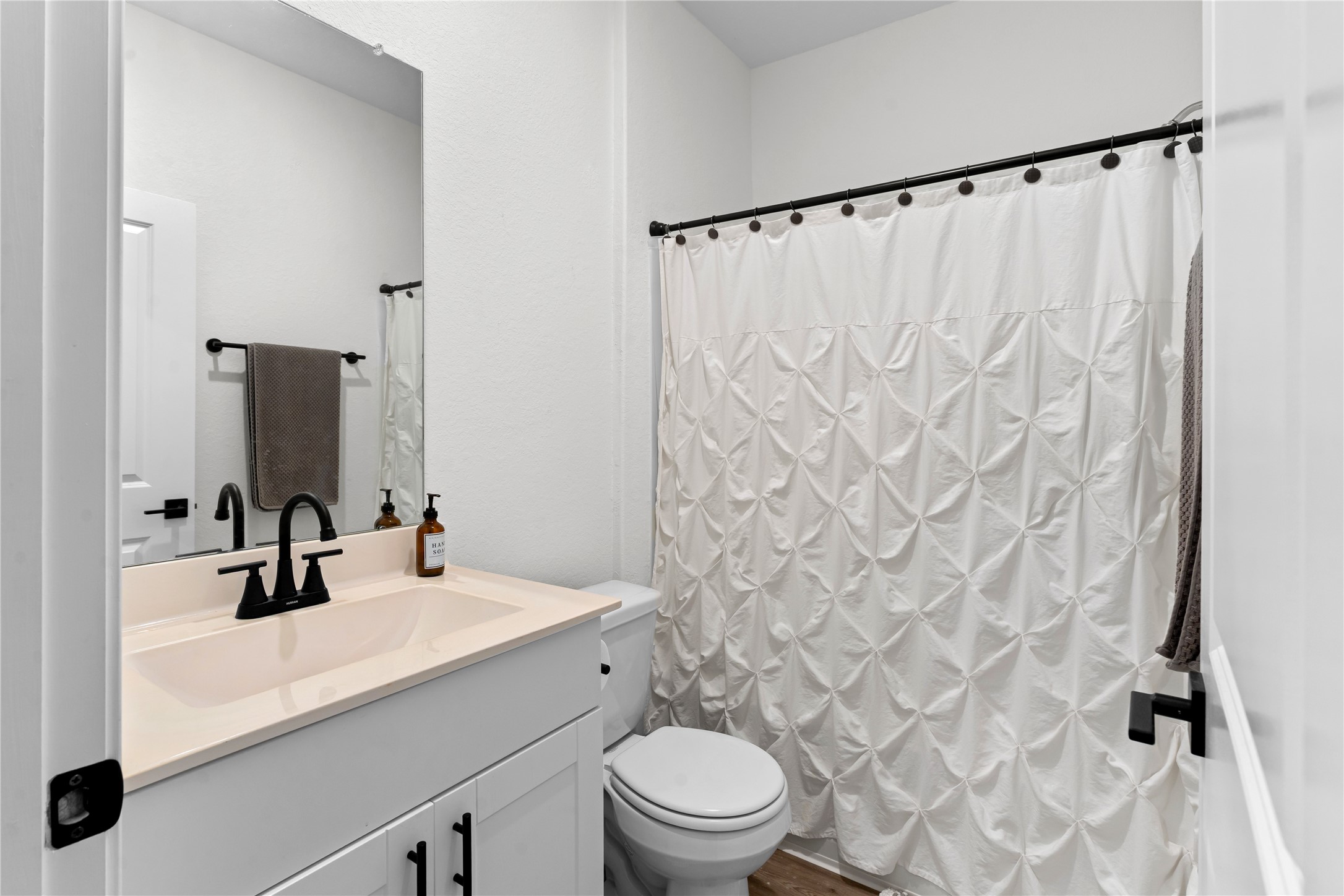 23439 Wrexham Street Spring, TX 77373 - Photo 16 of 26 a bathroom with a sink a toilet and a mirror