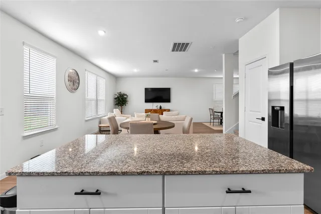 a kitchen with sink refrigerator and microwave