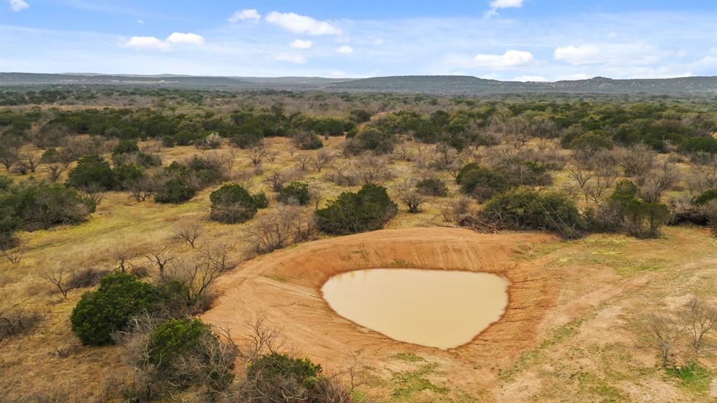 a view of a swimming pool with a yard
