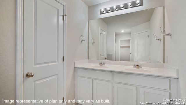 632 Fluted Shoals Cibolo, TX 78108 - Photo 11 of 24 a bathroom with a double vanity sink a mirror and shower
