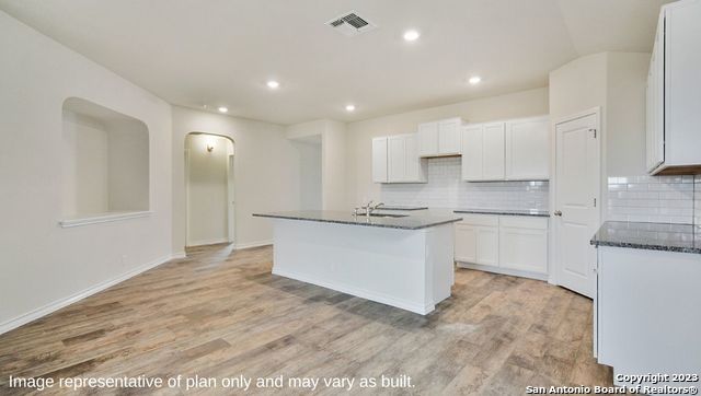 632 Fluted Shoals Cibolo, TX 78108 - Photo 5 of 24 a large white kitchen with kitchen island a sink stainless steel appliances and cabinets