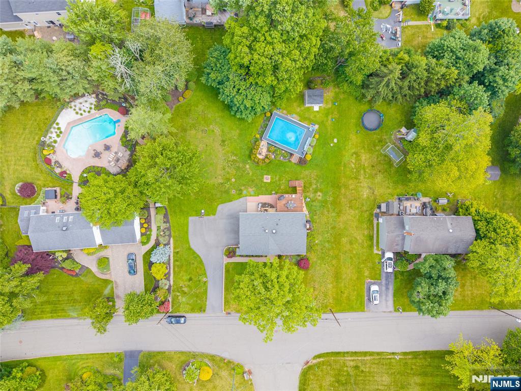 55 Marcia Road Ringwood, NJ 07456 - Photo 32 of 42 aerial view of a house with swimming pool and large trees