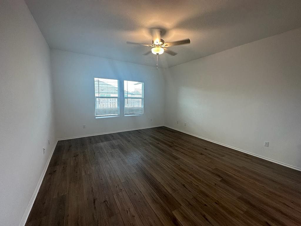 160 River Rise Road Kyle, TX 78640 - Photo 27 of 35 Bright interior space featuring wood-finish flooring, white baseboards, and a ceiling fan with integrated lighting