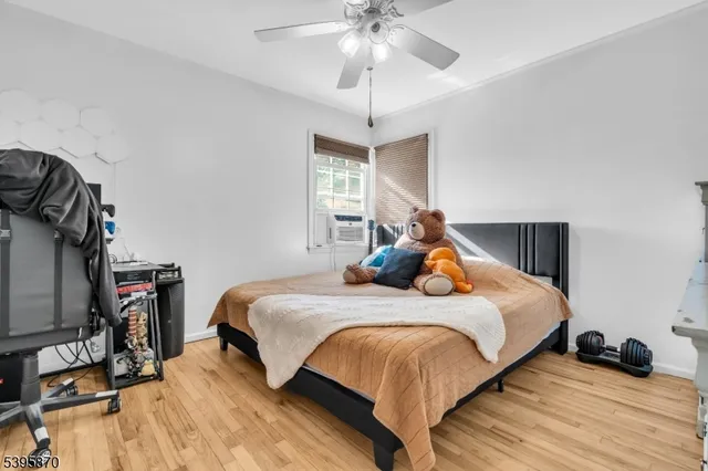 a bedroom with bed and two windows