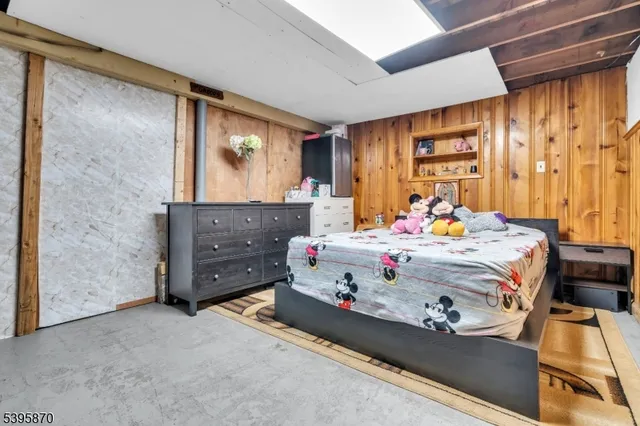 a bed room with a bed window and a dresser