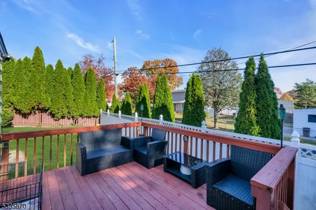 a view of a wooden chairs and table in the balcony
