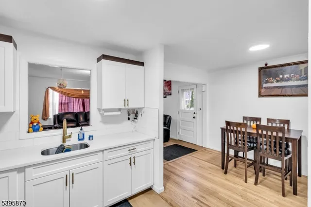 a kitchen with cabinets and wooden floor