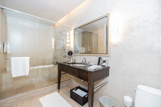 a bathroom with a sink a toilet and mirror