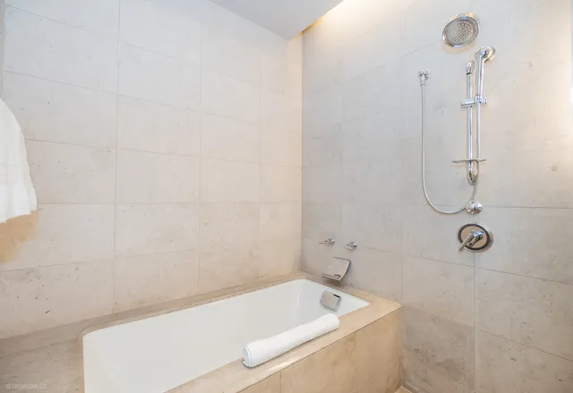 a bath tub sitting next to a white sink and vanity