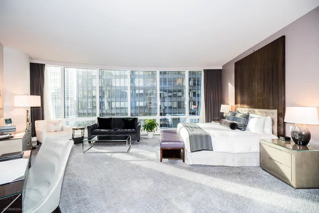 a living room with furniture and large windows