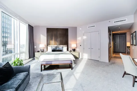 a spacious bedroom with a bed and a couch