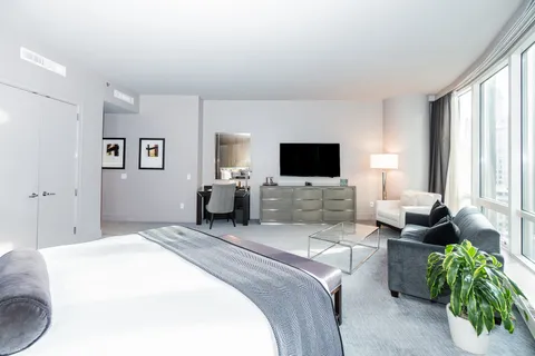 a bedroom with a bed and flat screen tv