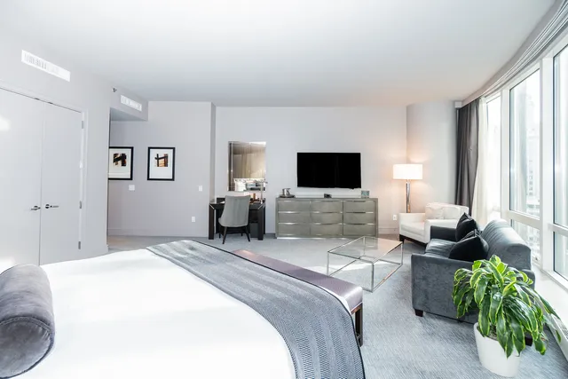 a bedroom with a bed and flat screen tv