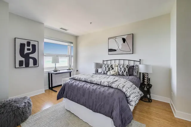 a bedroom with a bed and painting on the wall