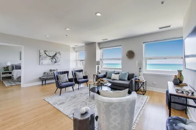 a living room with furniture a wooden floor and a flat screen tv