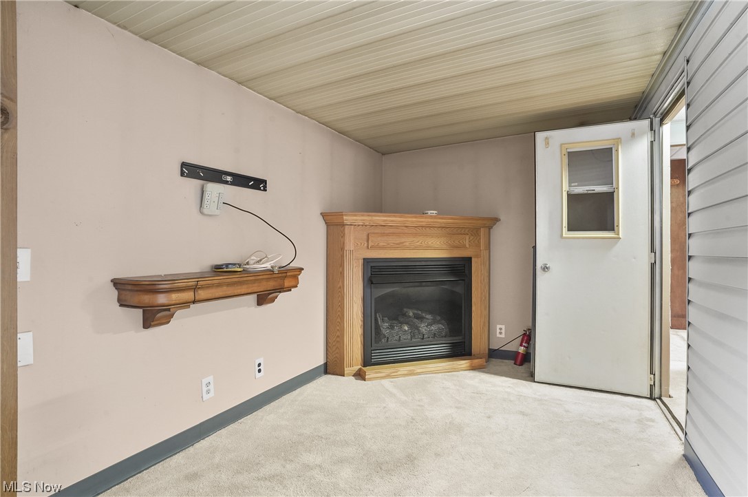 418 East Caston Road, Unit C1 Akron, OH 44319 - Photo 11 of 20 Unfurnished living room with light colored carpet