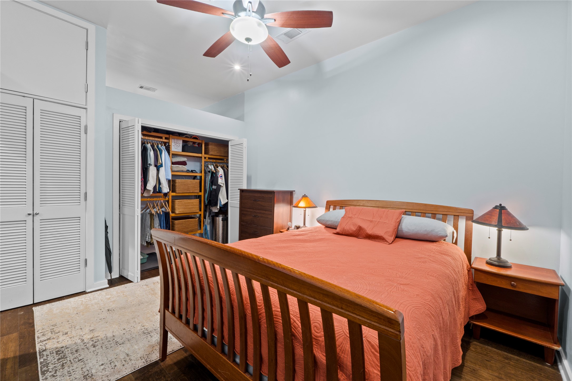 507 Sabine Street, Unit 509 Austin, TX 78701 - Photo 15 of 23 Bedroom with dark wood finished floors and ceiling fan