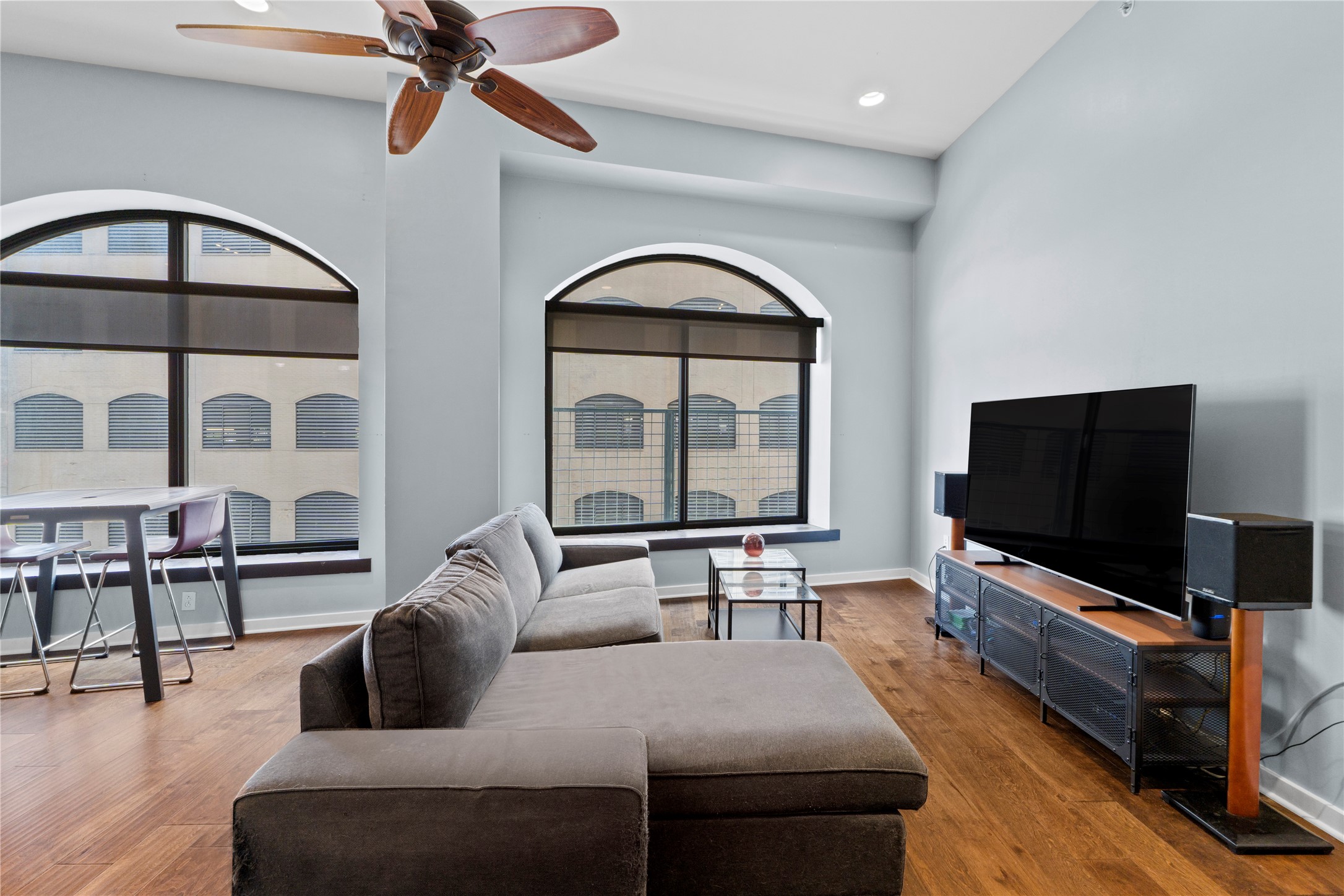 507 Sabine Street, Unit 509 Austin, TX 78701 - Photo 9 of 23 Living area with a ceiling fan, healthy amount of natural light, recessed lighting, and light wood finished floors