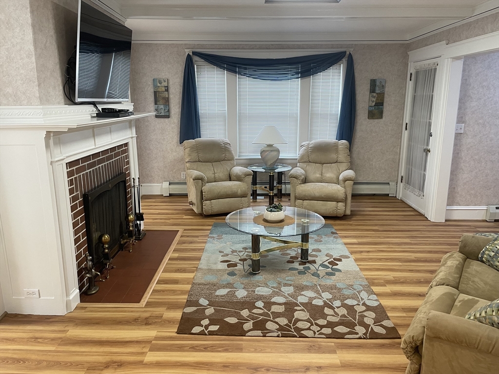 136 Russell Street, Unit 1A Worcester, MA 01609 - Photo 3 of 17 a living room with furniture and a fireplace