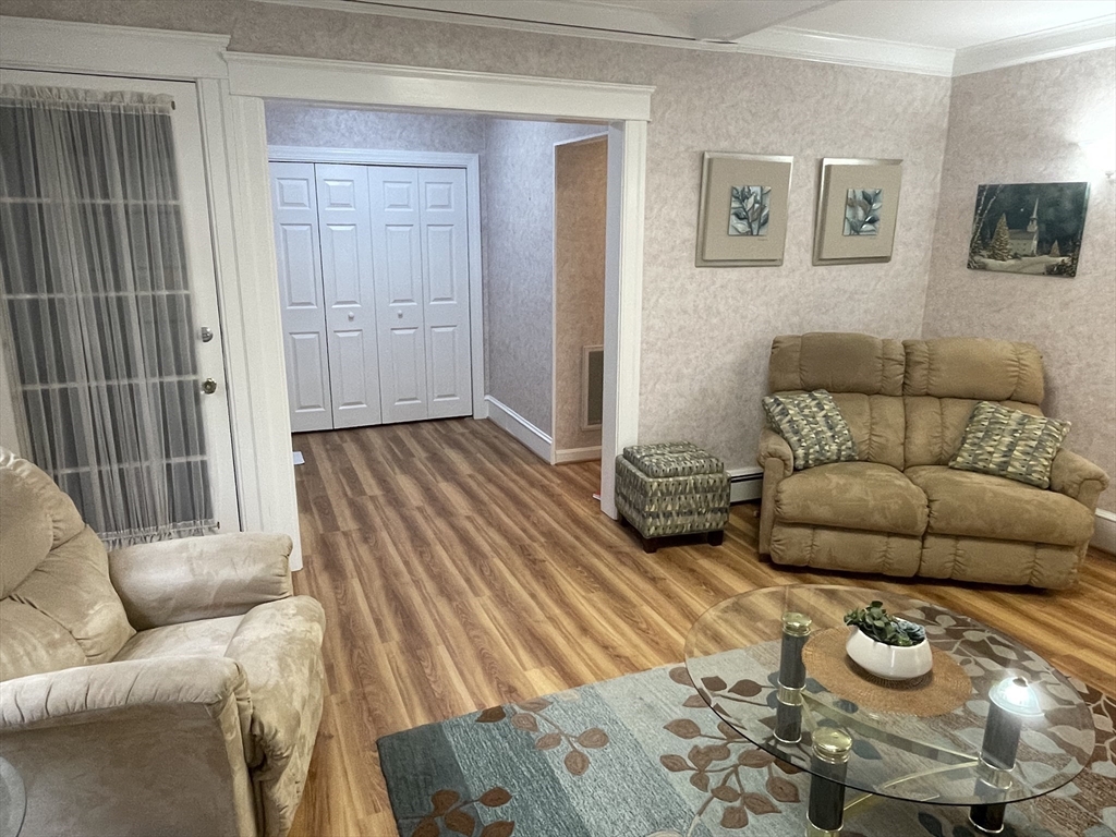 136 Russell Street, Unit 1A Worcester, MA 01609 - Photo 4 of 17 a living room with furniture and a wooden floor