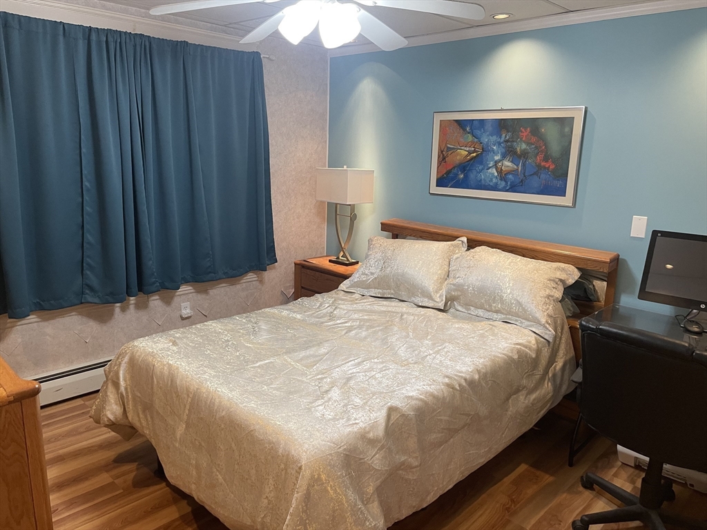 136 Russell Street, Unit 1A Worcester, MA 01609 - Photo 6 of 17 a large bed sitting in a bedroom next to a cabinet