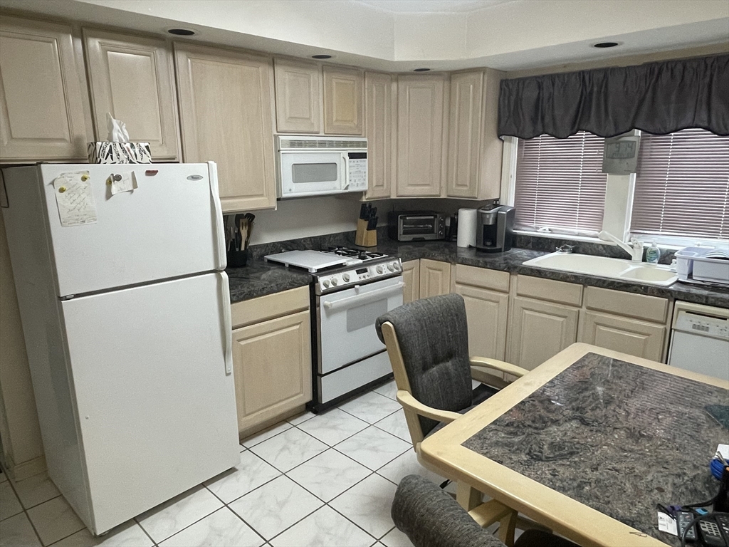 136 Russell Street, Unit 1A Worcester, MA 01609 - Photo 10 of 17 a kitchen with a sink a stove and white cabinets