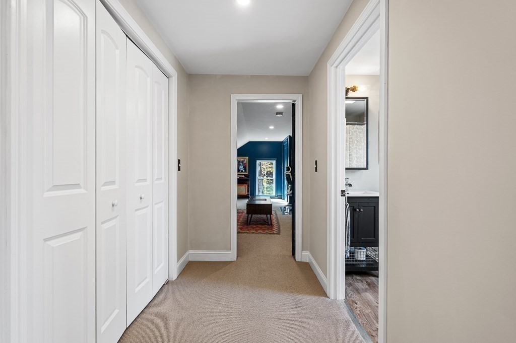 13 Blackstone Street Mendon, MA 01756 - Photo 31 of 41 a view of a hallway with wooden shelves