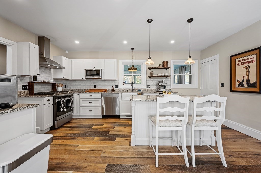 13 Blackstone Street Mendon, MA 01756 - Photo 9 of 41 a kitchen with stainless steel appliances kitchen island granite countertop a table chairs sink and cabinets