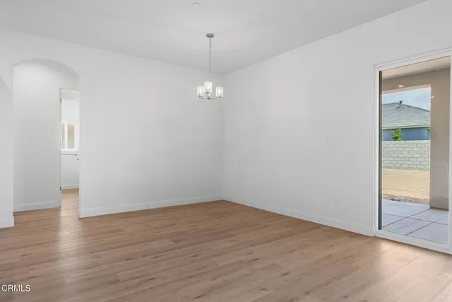 a large kitchen with stainless steel appliances granite countertop a large center island attached withe living room