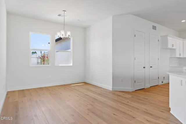 a large kitchen with granite countertop a large counter top and stainless steel appliances