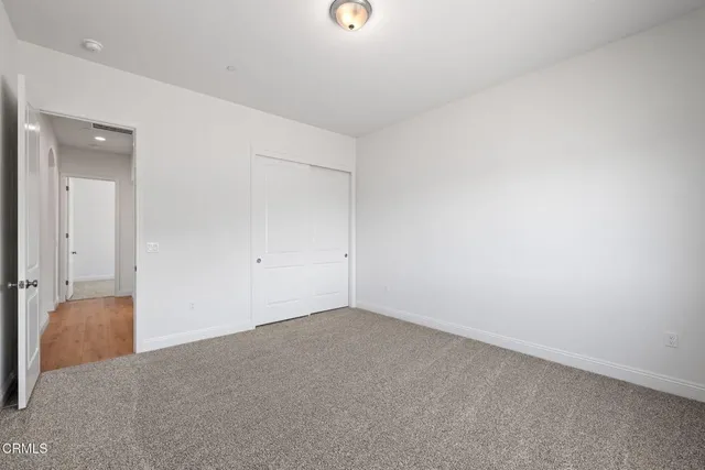 a bathroom with a toilet a sink a mirror and vanity