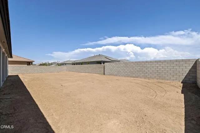 a big house with large trees and outdoor space