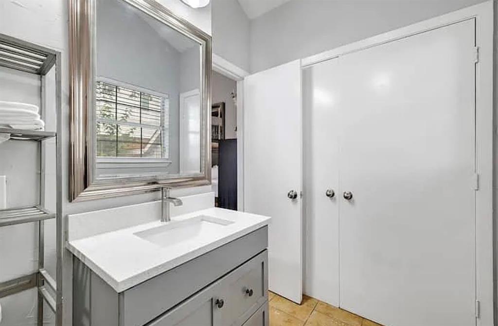 1718 Ripley Street Dallas, TX 75204 - Photo 19 of 33 Vanity with a rectangular undermount sink, brushed nickel faucet, and a large framed mirror