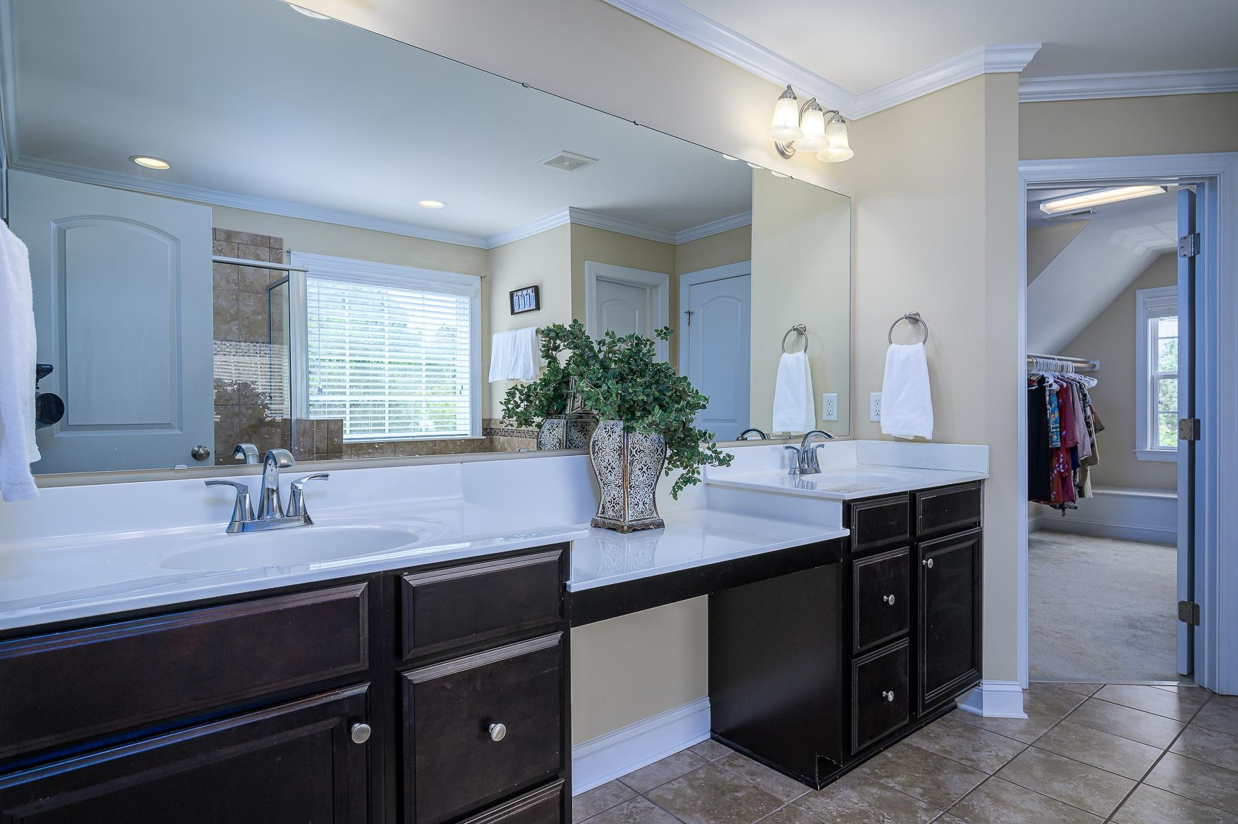 413 Mickey Lane Cary, NC 27513 - Photo 22 of 35 a bathroom with a granite countertop sink a large mirror and a bathtub