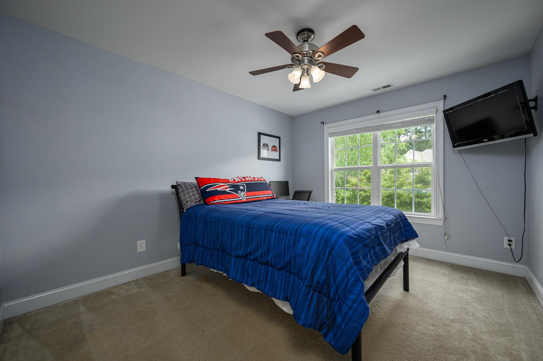 413 Mickey Lane Cary, NC 27513 - Photo 29 of 35 a bedroom with a bed and a flat screen tv