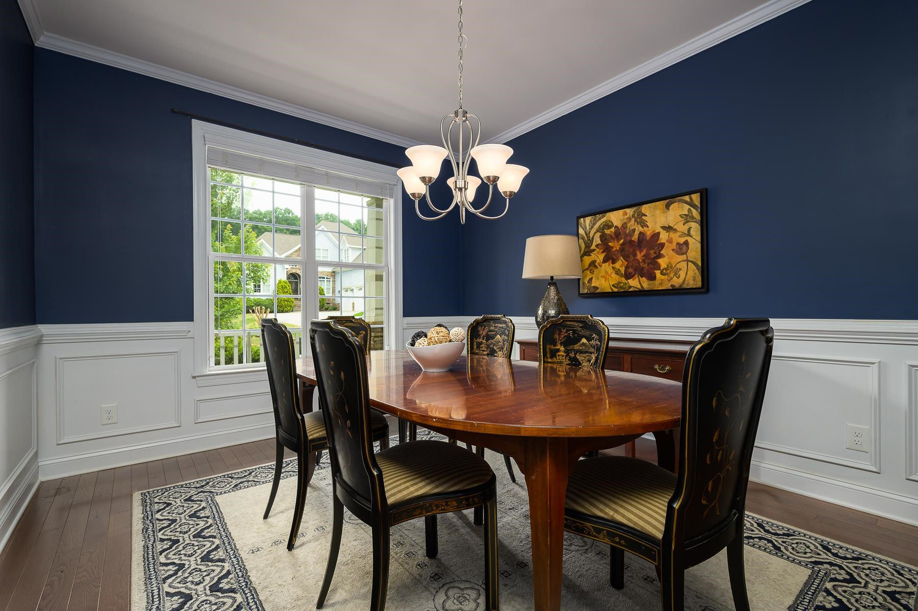 413 Mickey Lane Cary, NC 27513 - Photo 6 of 35 a dining room with furniture a potted plant and a chandelier